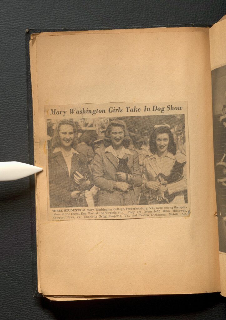 Newspaper clipping on a page from an article about Mary Washington Girls participating in a dog show. There's an image of three women holding dogs.