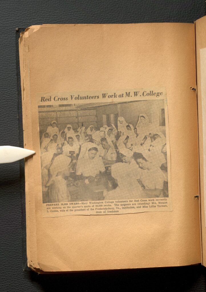 Newspaper clipping on a page. The image is of Red Cross Volunteers working at Mary Washington College.